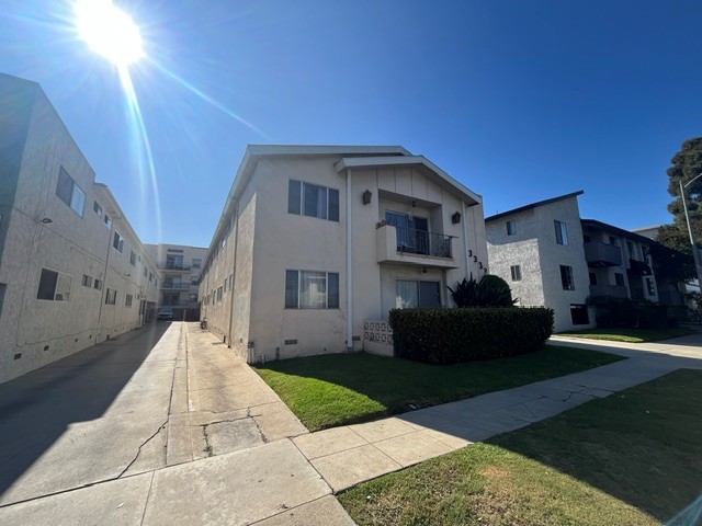 A sunny day in a residential area with houses on both sides of the street.